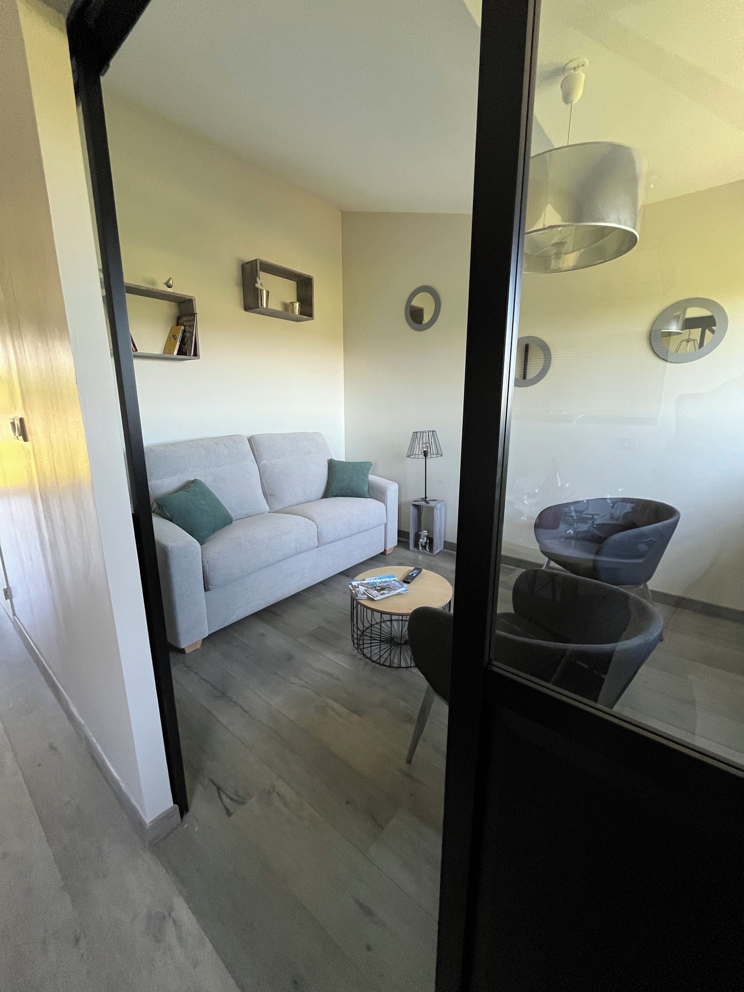 Ein Wohnzimmer mit Sofa, Couchtisch, Lampe und Sessel.