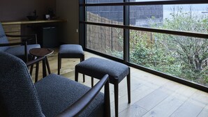 A modern room with a large window, a dining area, and a kitchen. - Miyajima Hanarenoyado IBUKU Bettei (Hatsukaichi)