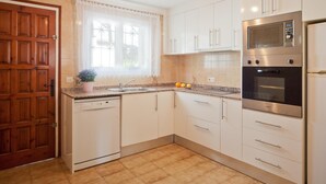 A kitchen with white cabinets, a built-in microwave, an oven, and a dishwasher. - Villa with swimming-pool and garden.HUTG-015589 (l'Escala)