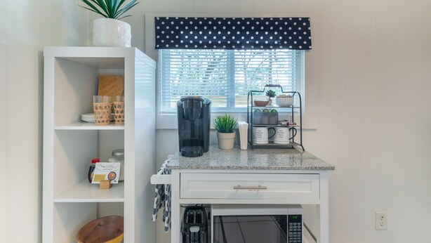 A kitchen with a microwave, coffee maker, and a window with blinds. - 1BR NEAR WATER + HEART of CR RIVER-Manatees, Golf, Fish, Beach, Food (Crystal River)