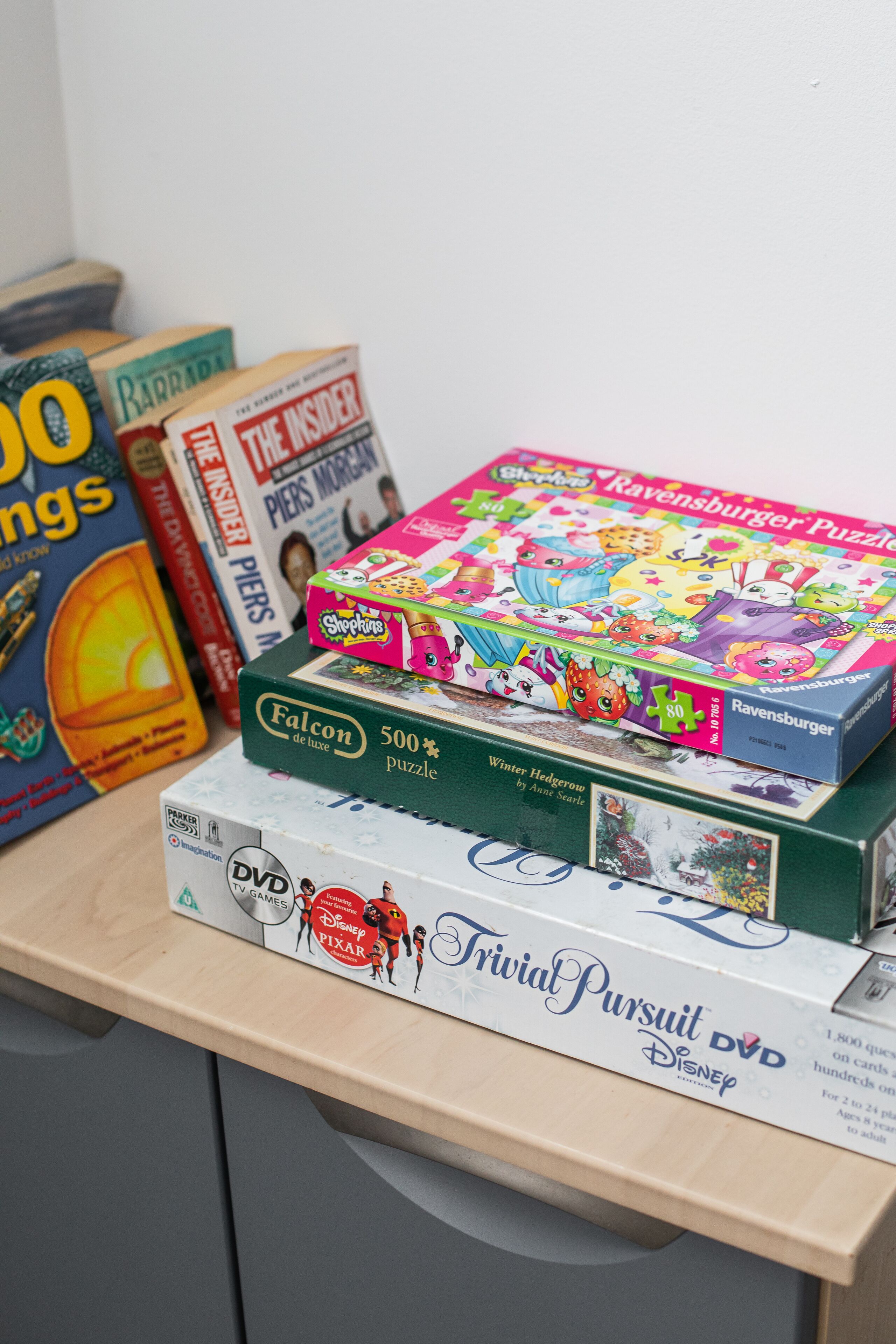 A desk with various puzzles and a DVD.