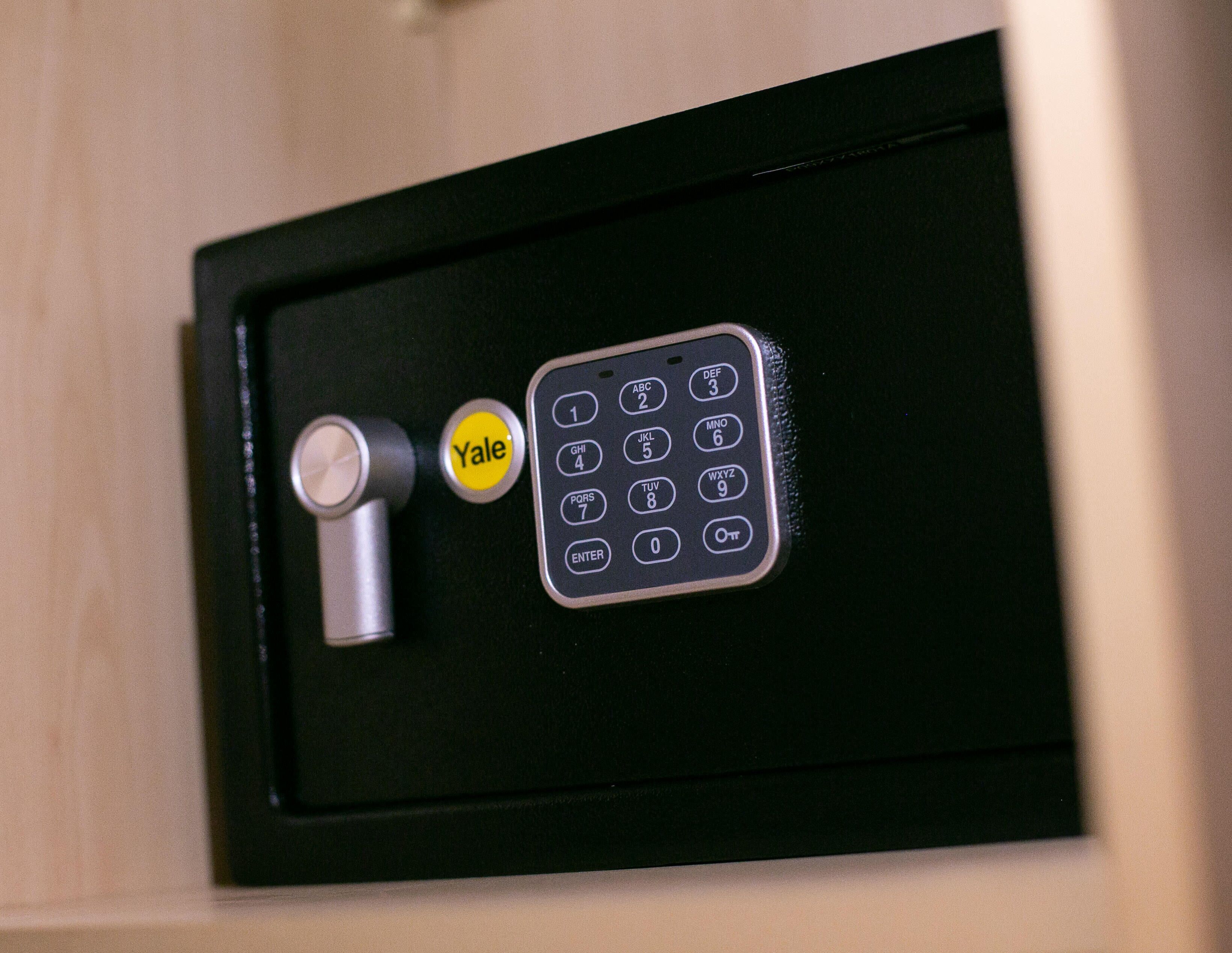 A Yale deadbolt lock and a keypad on a door.