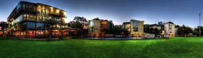 A modern building with multiple floors, large windows, and a well-maintained lawn in front. - High Performance Center (Pretoria)