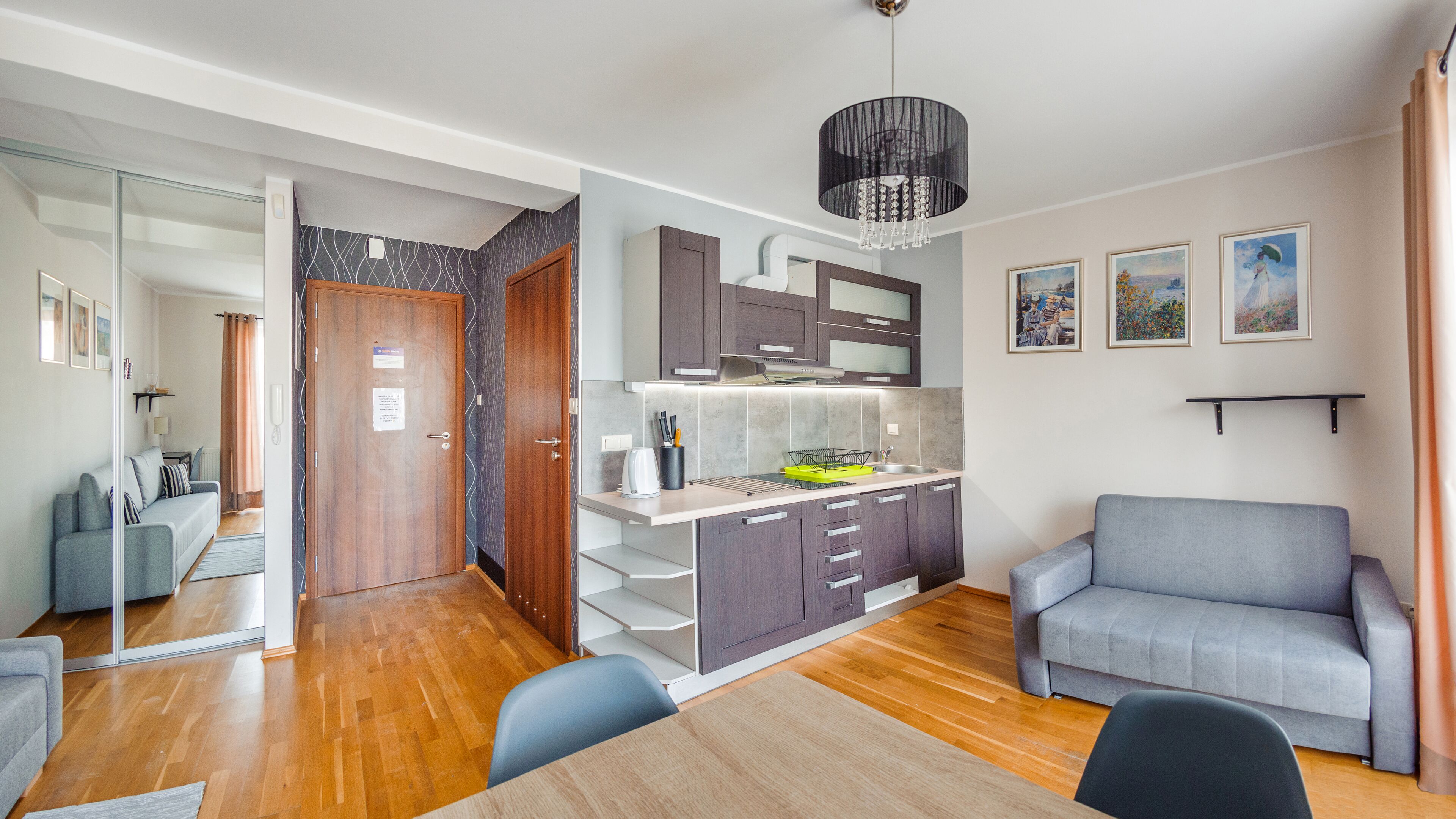 A modern apartment with a kitchen, dining area, and living room.