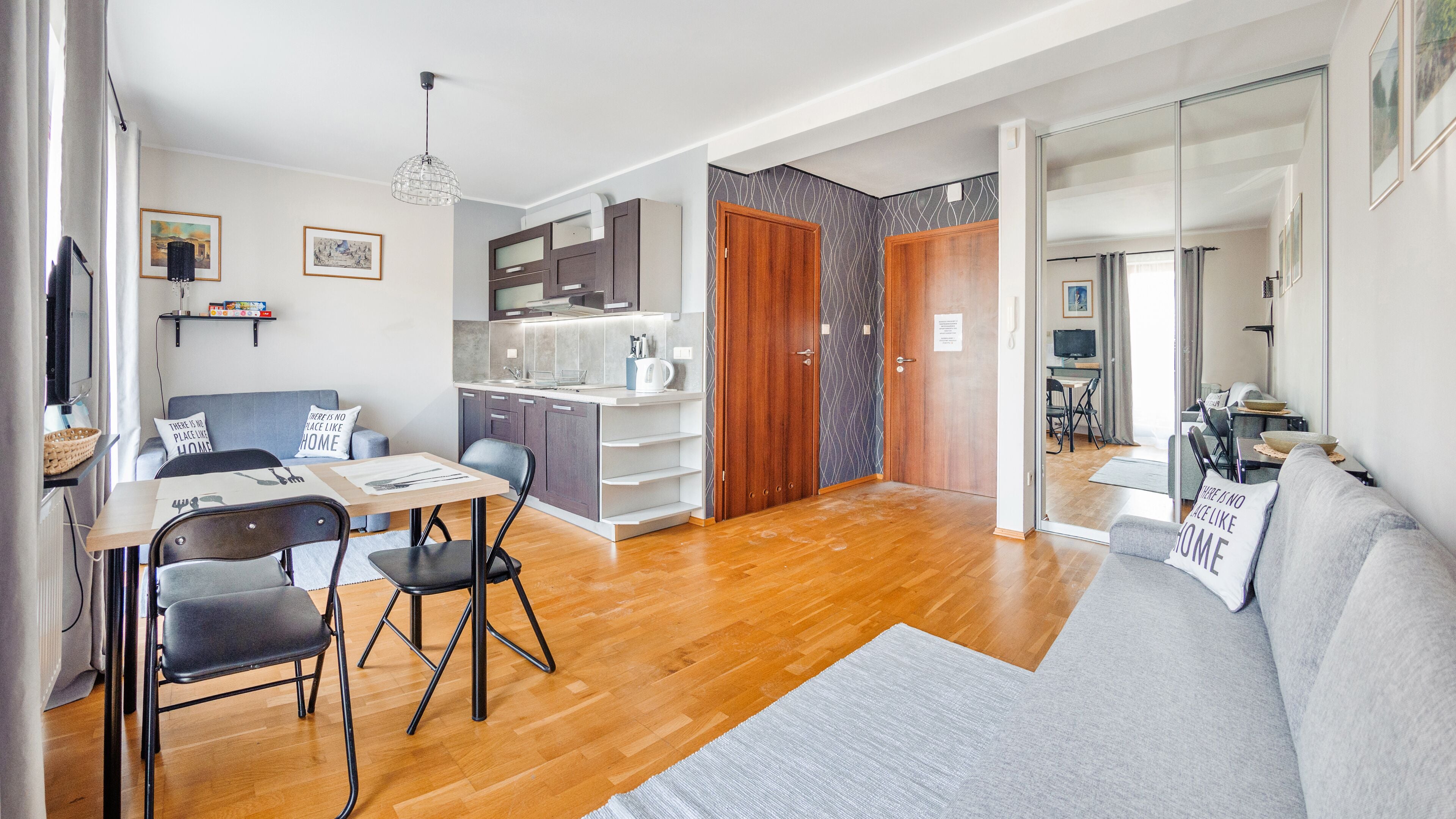 A modern apartment with a dining area, kitchen, and living room.