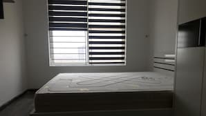 A small, compact room with a single bed, a window with blinds, and a built-in wardrobe. - Nhimhouse   Hanoi... (Thanh Xuân)