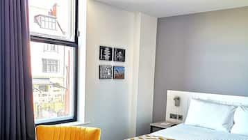 Premium bedding, desk, laptop workspace, blackout curtains