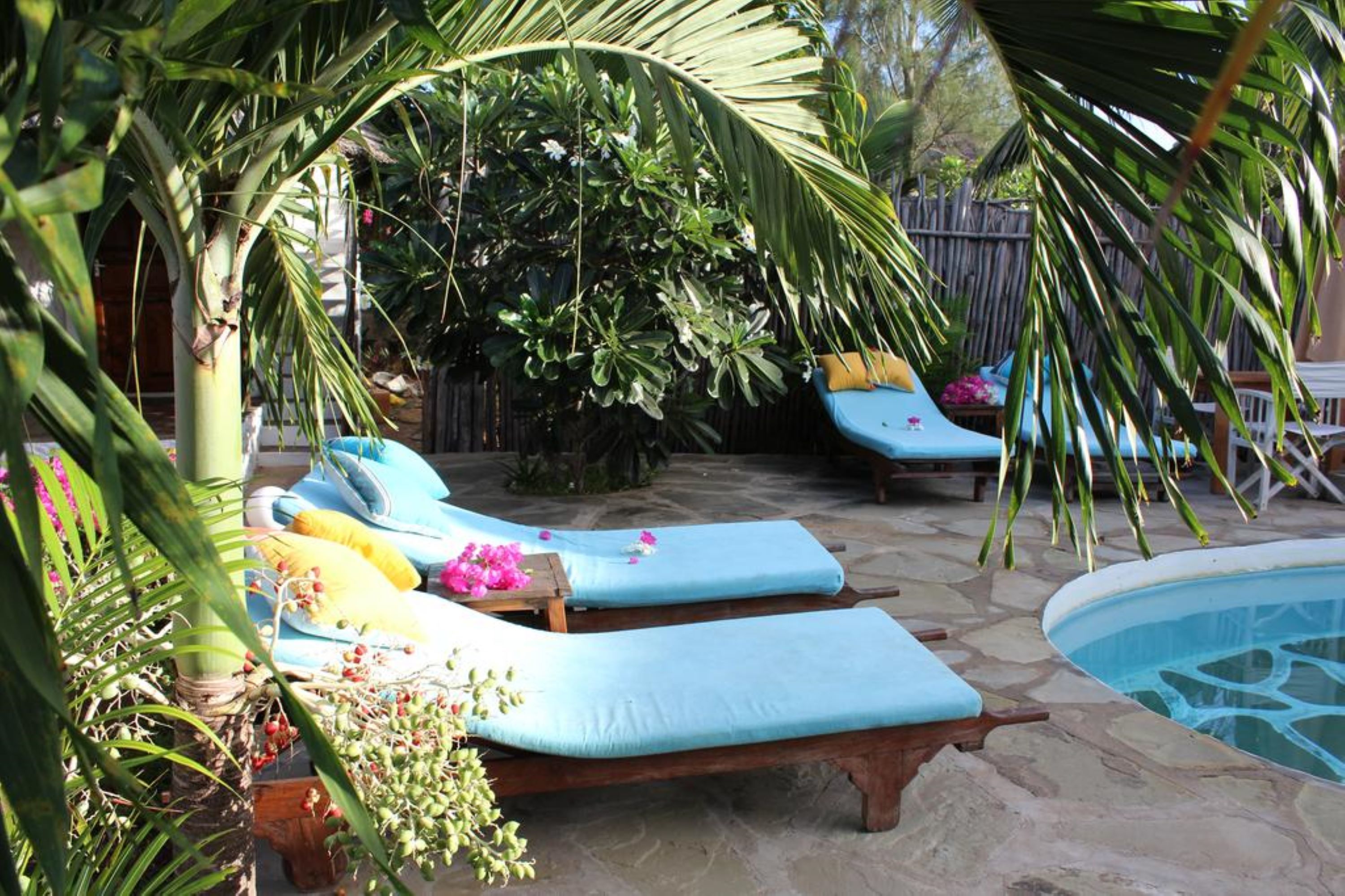 A poolside area with lounge chairs and a small pool.