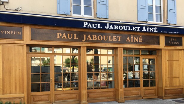 A storefront with large glass windows and wooden doors, labeled "Paul Jaboulet Ainé". - Les Gîtes de la Galaure (Châteauneuf-de-Galaure)