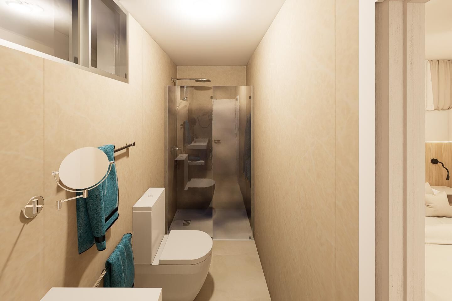 Un banyet petit amb un vàter, un lavabo i una dutxera.