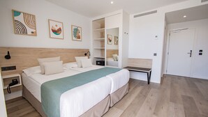 A modern hotel room with a large bed, built-in shelving, and artwork on the walls. - Servatur Hartaguna - Adults Only (Mogan)