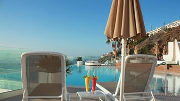 Una piscina al aire libre, sombrillas