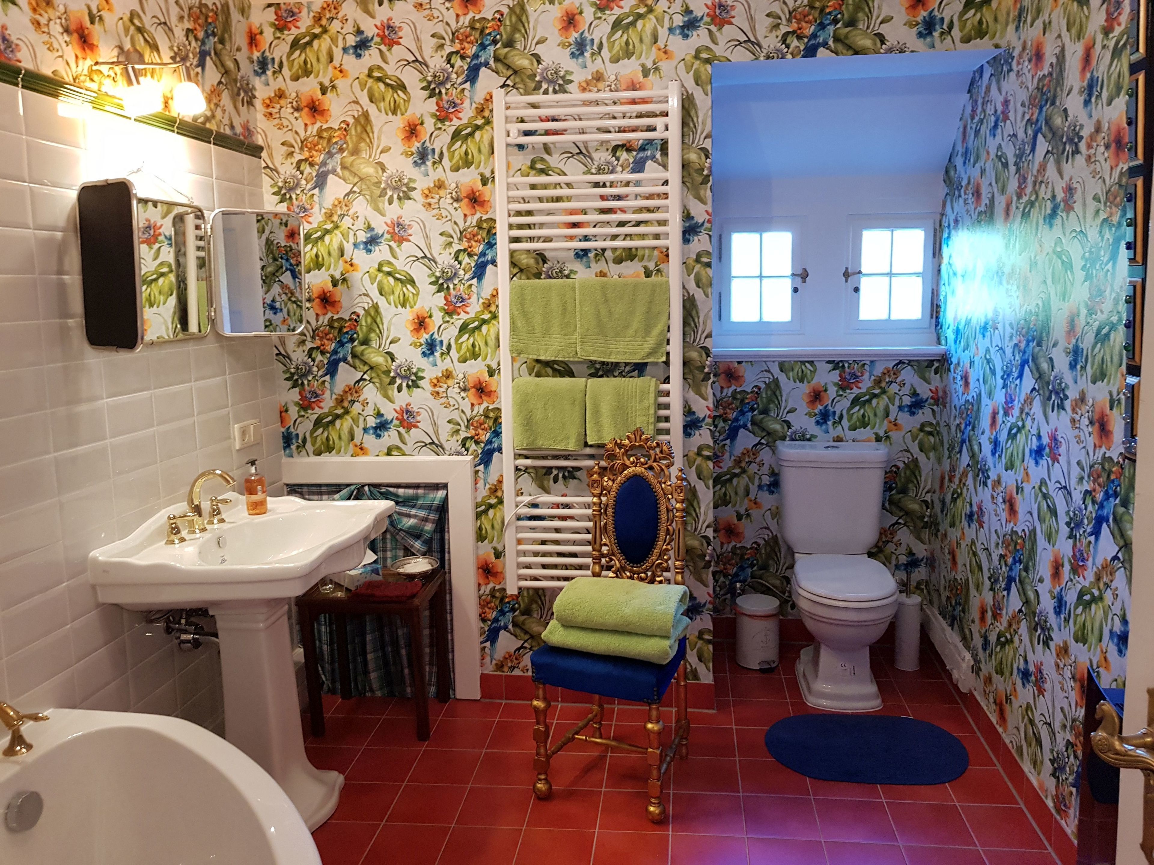 A bathroom with a white sink, a bathtub, a toilet, and a shower area.
