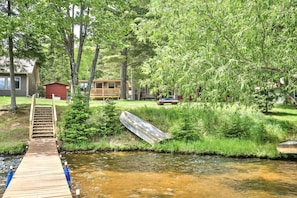 Escape to a serene lakeside retreat surrounded by lush greenery and tranquil water.