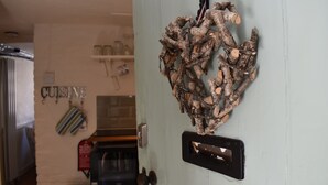 A kitchen with a rustic decor, including a wooden wall hanging and a 'CUISINE' sign. - Old Town Bolthole (Hastings)
