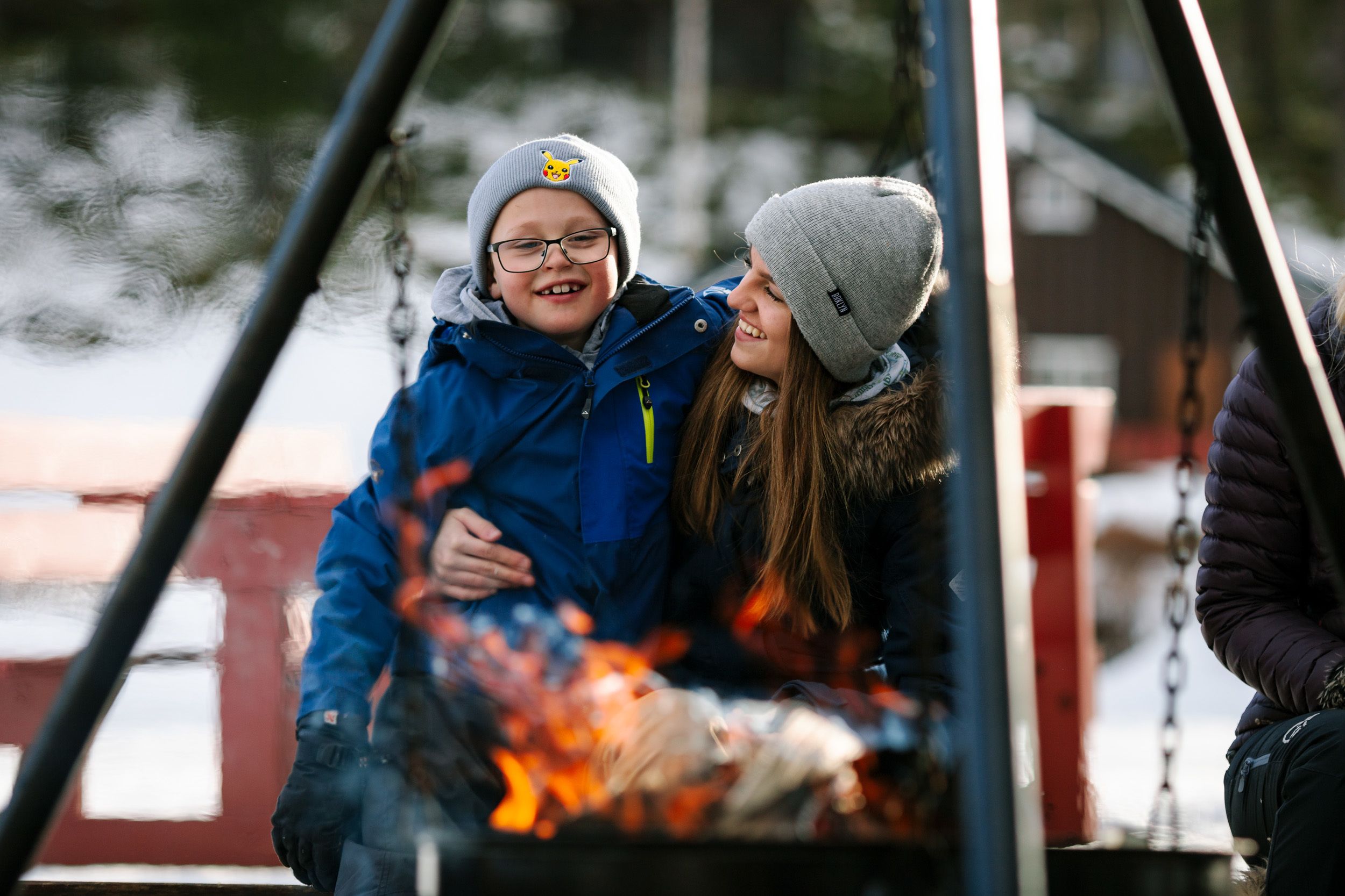 A person sitting by a fire.