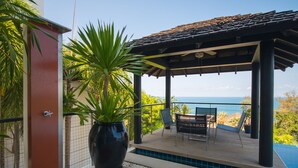 A covered outdoor area with a pool, seating, and a large potted plant. - Beautiful 3-Bedroom Villa at Surin Beach (Choeng Thale)