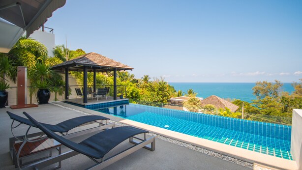 A rooftop infinity pool with lounge chairs, a gazebo, and a view of the ocean. - Beautiful 3-Bedroom Villa at Surin Beach (Choeng Thale)