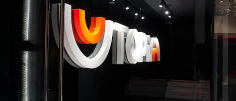A modern interior with a prominent illuminated sign reading "UTOPIA".