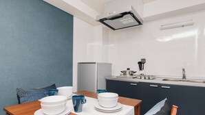 A compact kitchen with a refrigerator, sink, and modern appliances. - AFP Shimanouchi J Apartment (Osaka)