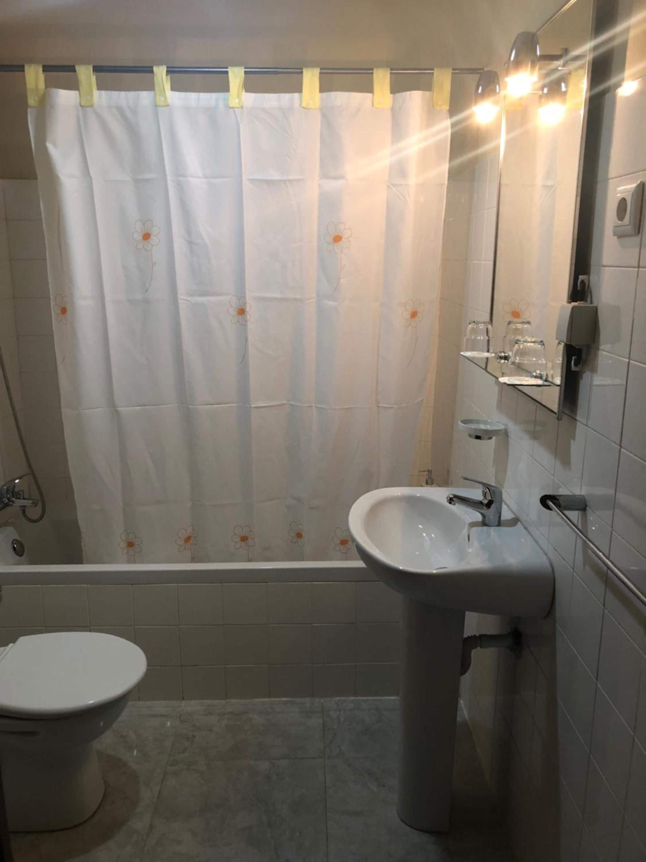 A bathroom with a bathtub, a sink, and a toilet.