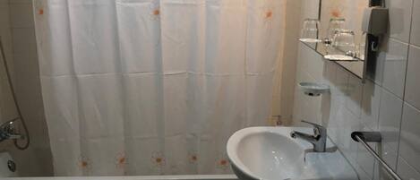 A bathroom with a bathtub, a sink, and a toilet.