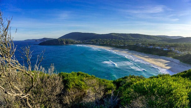 A coastal landscape with a beach, ocean, and hills in the background. - Aqua Apartment #1 - Pacific Palms Holidays (Blueys Beach)