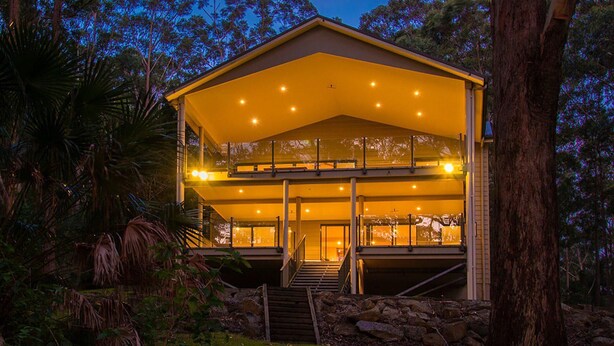 A two-story building with a balcony and a staircase leading to the entrance. - A Yarraangunthi at Smiths Lake (Smiths Lake)