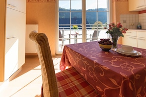 Enjoy a romantic dinner for two in this inviting dining area, complete with a beautifully set table and a lovely view of the outdoors.