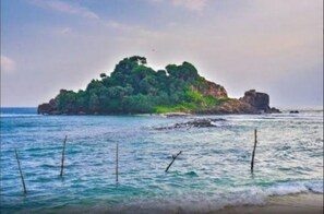 Escape to a serene island paradise surrounded by lush greenery and calm turquoise waters.