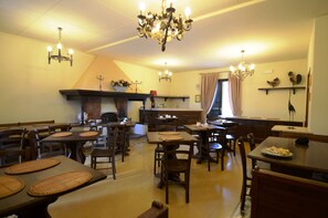 Guests can dine and socialize in this inviting space, surrounded by comfortable seating and decorative accents.