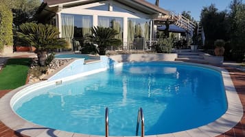 Seasonal outdoor pool, open 10:00 AM to 7:30 PM, pool umbrellas