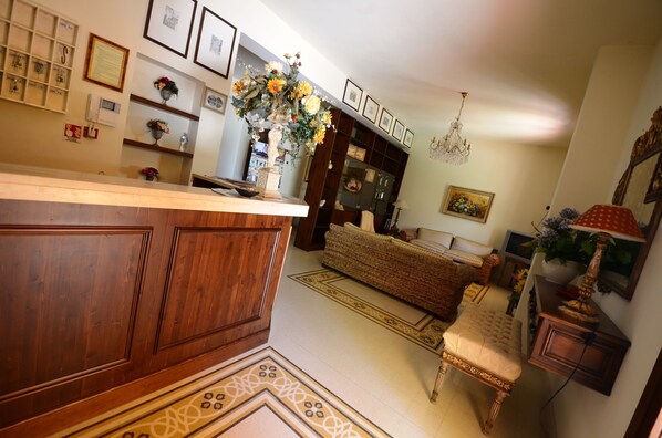 A cozy living room with a wooden coffee table, a sofa, and a patterned rug.