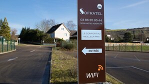 A sign for a hotel named SOFRATEL with contact information and a WiFi symbol. - Sofratel (Joigny)