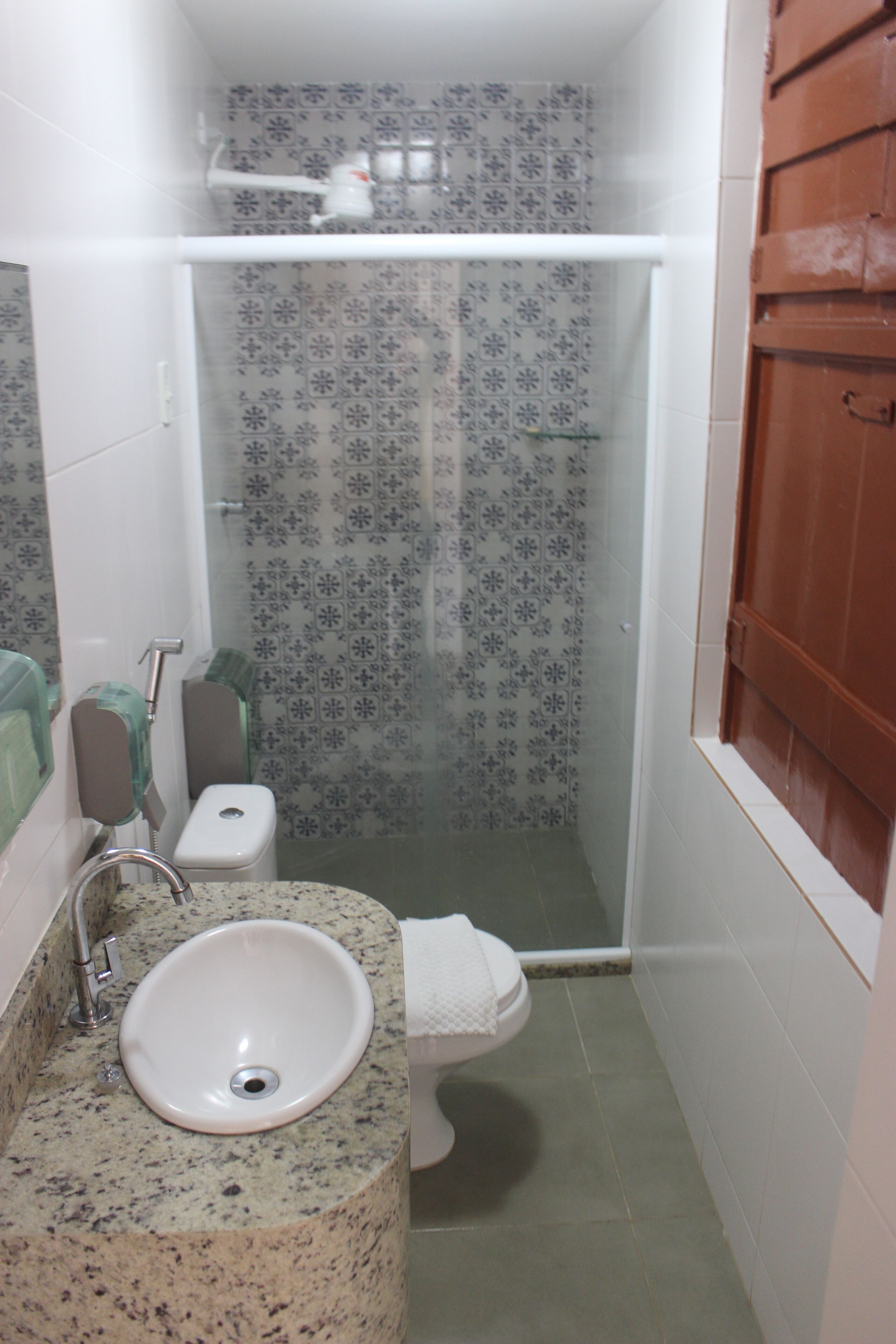 A bathroom with a sink, toilet, and shower.