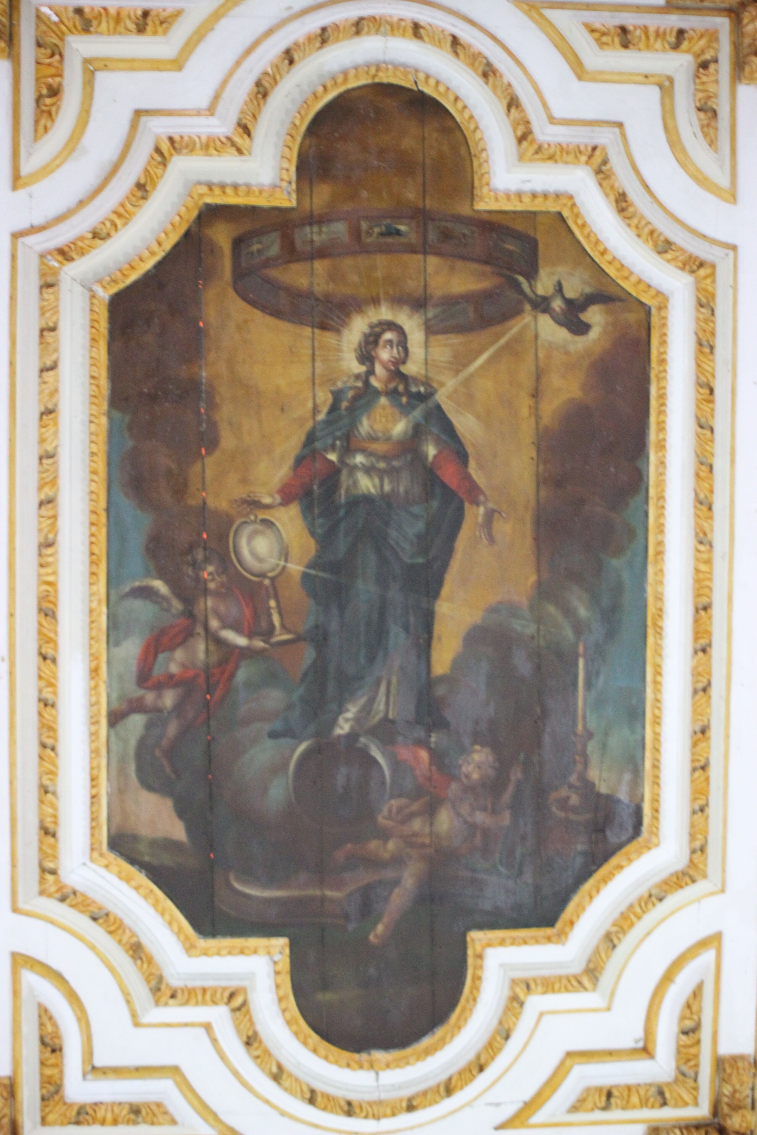 A detailed mural with a central figure, surrounded by ornate golden frames and a complex architectural background.