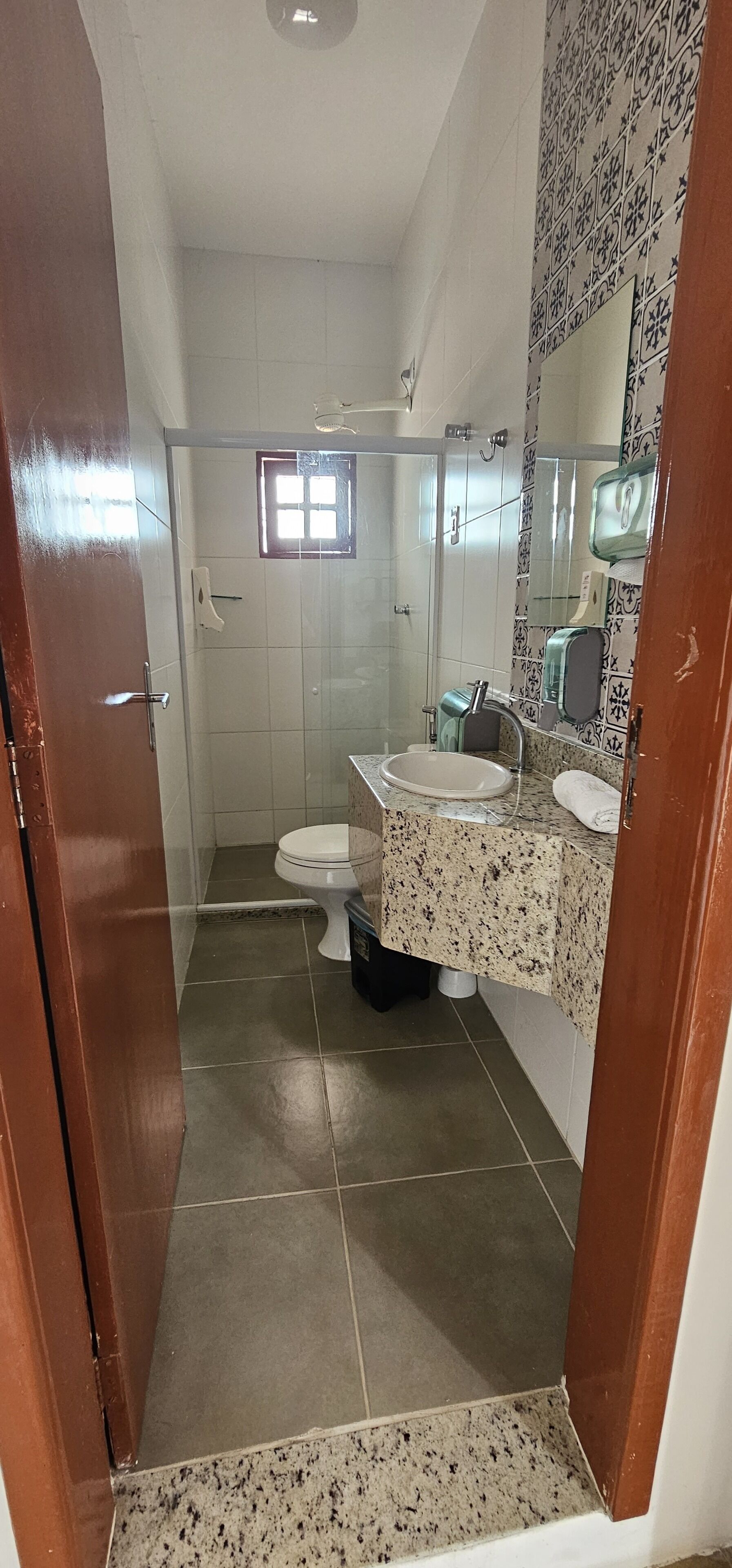 A bathroom with a shower, toilet, and sink.