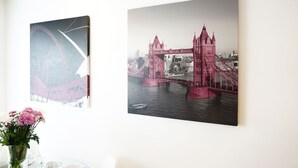 Two framed artworks on a wall, one depicting a bridge and the other a cityscape. - Superior Canary Wharf  O2 Arena 2Bed Apartment (Greater London)