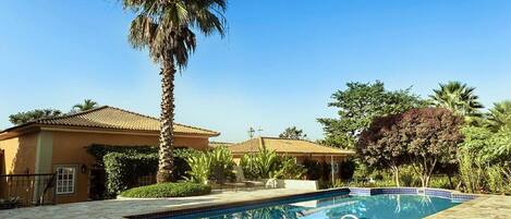 Piscina all'aperto, ombrelloni da piscina, lettini