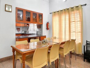 Enjoy meals in the dining area with a stove and sink, and relax in this cozy space.