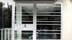 A modern building entrance with a glass door and a metal frame. - Rent 2888 (Buenos Aires)