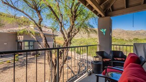 A covered outdoor patio with a view of a mountain range, a tree, and a house in the background. - Rare 3 Bedrm 2 Bath corner unit with unobstructed Spectacular Mountain Views (Tucson)
