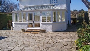 A white house with a conservatory.