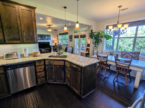 Welcoming home overlooking lake with forested hill country views