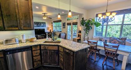 Welcoming home overlooking lake with forested hill country views