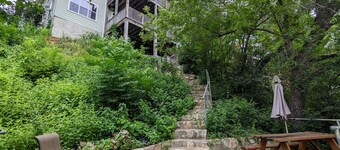 Welcoming home overlooking lake with forested hill country views
