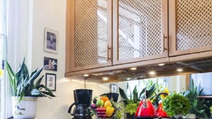 A kitchen with dark blue cabinets, a coffee maker, and various potted plants on the counter. - MORNING CHECK-IN IS GIVEN WHEN POSSIBLE -3BEDROOMS/2BATHS KNIGHTSBRIDGE (LONDON)