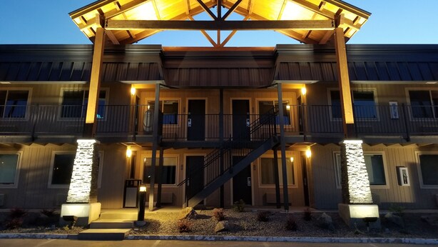 A multi-story hotel with a covered entrance, balconies, and a staircase. - The Hotel Y, a Dazzler Select by Wyndham (Yakima)