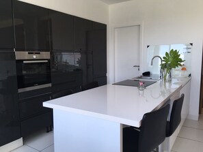 Microwave, dishwasher, coffee/tea maker, cookware/dishes/utensils