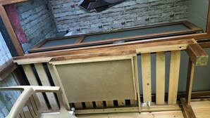 A room with a wooden floor, a plastic chair, and a wooden table. - Eco-flat camping in mountain (Batumi)